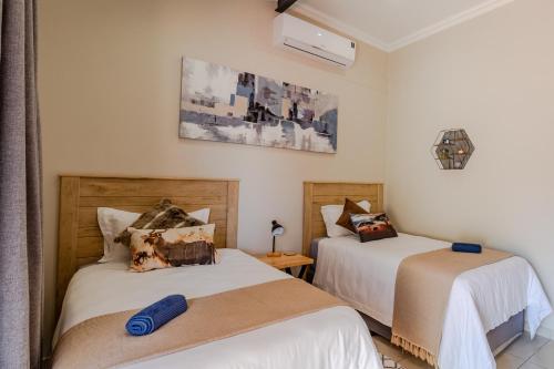 two beds sitting next to each other in a room at Guest On Wynne in Centurion