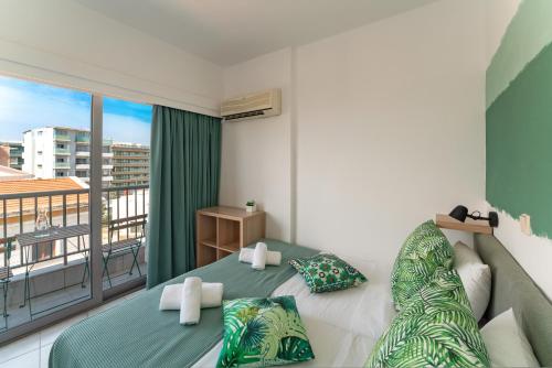 a bedroom with a bed and a balcony at STAY Rhodes Hotel in Rhodes Town