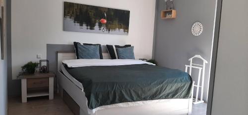 a bedroom with a large bed with blue pillows at Great apartment Winterberg WOODS in Medebach