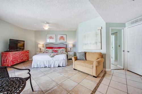 a bedroom with a bed and a chair and a tv at Sterling Sands 514A in Destin