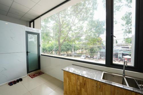 a kitchen with a sink and a large window at Thanh Ngoc Motel 2 in Buon Ma Thuot