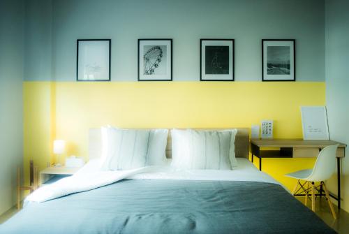 a bedroom with a large bed with white pillows at Into the town krabi in Krabi town