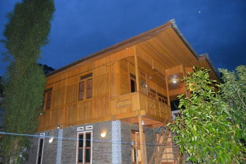 a large wooden house on top of a building at THE SINGKI HOME FAMILY in Rantepao