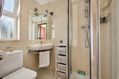 a bathroom with a shower and a toilet and a sink at Celina by Algarve Villa Holidays in Guia