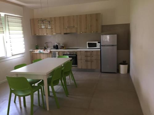 a kitchen with a table and chairs and a refrigerator at Inviting 2-Bed Apartment in Resana in Resana