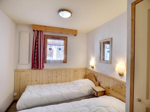 a bedroom with two beds and a window at Appartement Les Menuires, 3 pièces, 6 personnes - FR-1-178-319 in Les Menuires