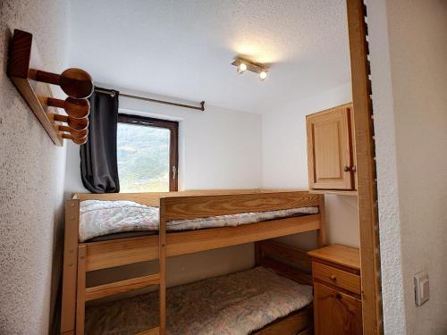 une chambre avec deux lits superposés et une fenêtre dans l'établissement Joli 2P pour 4, au pied des pistes, quartier Bruyères, Les Menuires - FR-1-178-332, aux Menuires