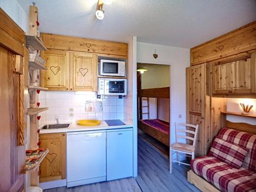 une petite cuisine avec un évier et un micro-ondes dans l'établissement Studio 4 pers, pied des pistes - Résidence Carlines I, Les Menuires, quartier animé des Bruyères - FR-1-178-346, aux Menuires