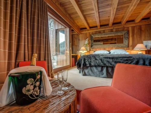 a bedroom with a bed and two chairs and a table at Chalet Val-d'Isère, 6 pièces, 12 personnes - FR-1-519-32 in Val-d'Isère