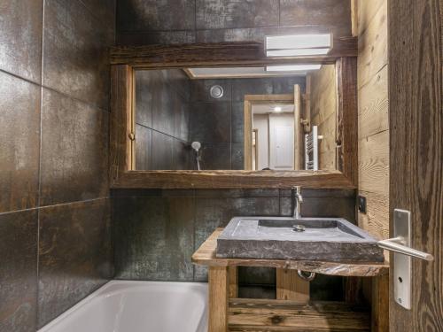 a bathroom with a tub and a sink and a mirror at Appartement Val-d'Isère, 3 pièces, 6 personnes - FR-1-519-31 in Val-d'Isère