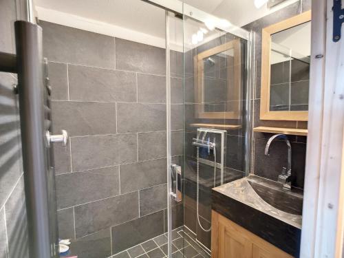 une salle de bain avec douche et lavabo dans l'établissement Beau 2P rénové 24m², ski aux pieds, balcon, parking, animaux admis - FR-1-178-357, aux Menuires