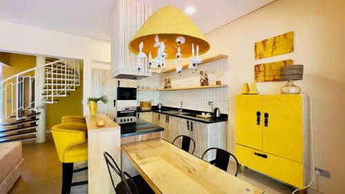 a kitchen with a table and a yellow refrigerator at Kabira Country Club in Kampala