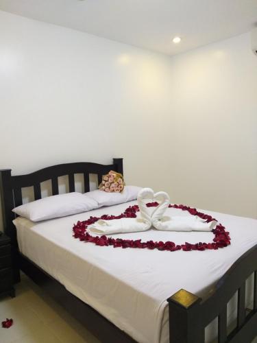 a bed with a flower arrangement on it at Villa Del Faro in Batangas City