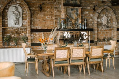 a dining room with a wooden table and chairs at Papazlıkhan Hotel in Altınoluk