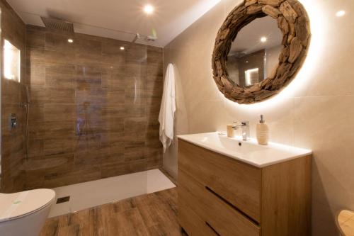 y baño con lavabo y ducha con espejo. en Room in Guest room - Private room with beautiful sea view, en Marbella