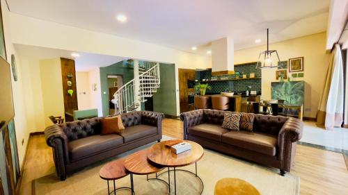 a living room with two couches and a table at Kabira Country Club in Kampala