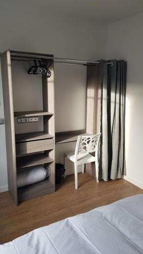 a bedroom with a closet with a chair and a bed at Maison Deluxe, moderne, calme, terrasse, proche chantiers de l'Atlantique et Airbus in Saint-Nazaire