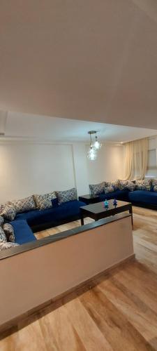 a living room with a couch and a table at Apartment place italie in Rabat