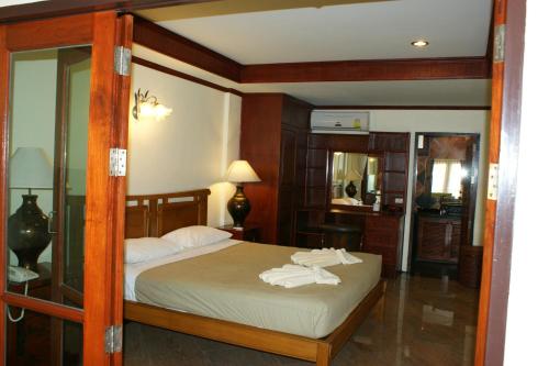 a bedroom with a bed with white towels on it at Prince Edouard Apartments & Resort Patong Beach Phuket in Patong Beach