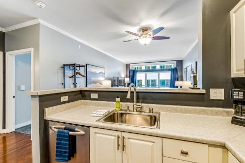 a kitchen with a sink and a ceiling fan at Second Star in Seattle