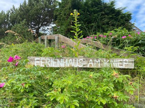 a sign in the middle of a field of flowers at Ferienhaus am Kniep in Wittdün