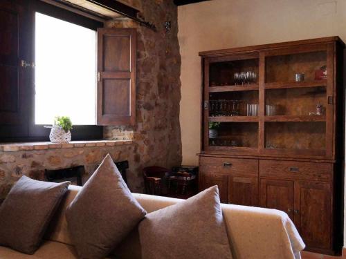 a living room with a couch and a window at Can Toni Vell Espinelves in Espinelvas