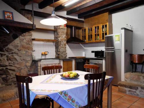 - une cuisine avec une table et un bol de fruits dans l'établissement Can Toni Vell Espinelves, à Espinelvas