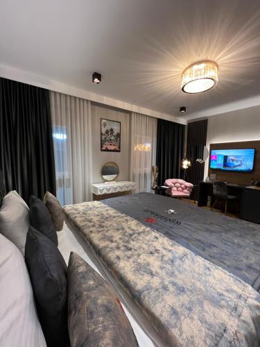 a large bed in a living room with a couch at Design Hotel Winterrot in Karlsruhe