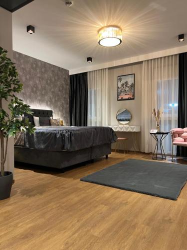 a bedroom with a bed and a living room at Design Hotel Winterrot in Karlsruhe