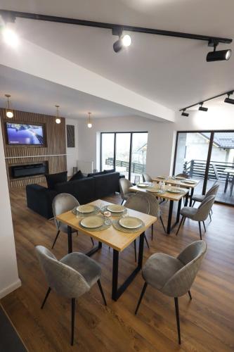 a living room with tables and chairs and a couch at Pensiunea CityView in Câmpulung Moldovenesc