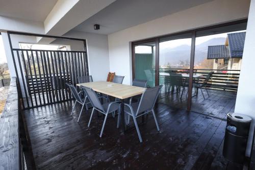 a dining room with a table and chairs on a balcony at Pensiunea CityView in Câmpulung Moldovenesc