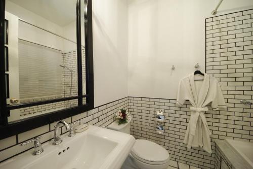 a bathroom with a sink and a toilet and a mirror at 99 The Heritage Hotel in Chiang Mai