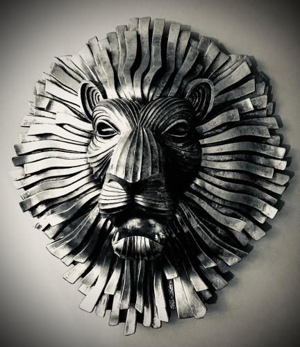 a wooden carving of a lion head on a wall at The Capon Tree Town House in Jedburgh