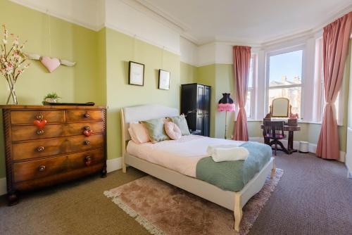 a bedroom with a bed with a teddy bear on it at 5-Bed House with distant sea views in Plymouth in Plymouth