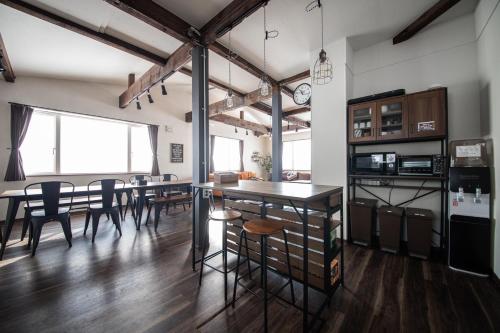 a kitchen and dining room with a table and chairs at Yadoya YADOKARI in Pippu