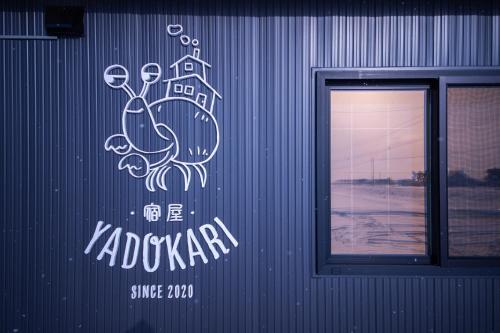 a sign on the side of a building with a crab at Yadoya YADOKARI in Pippu