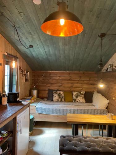 um quarto com uma cama num chalé de madeira em Mikrohyttene Moen Ranch em Kragerø