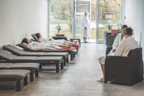 a group of people laying in chairs in a waiting room at Wellness- & Sporthotel Haus am See in Arendsee