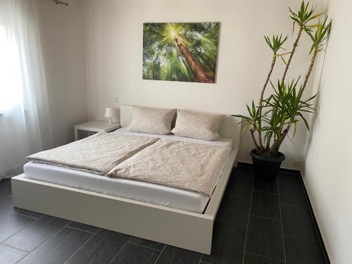 a bedroom with a bed and a painting on the wall at Haus Seeblick in Allersberg