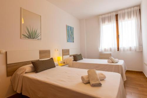a room with two beds and a couch at Apartagal-Playa de Llas, Foz in Foz
