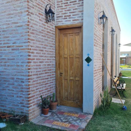 a wooden door on the side of a brick building at Inocencia Faez in Roldán