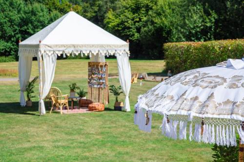 a white gazebo in a yard with a table at Trading Boundaries in Uckfield