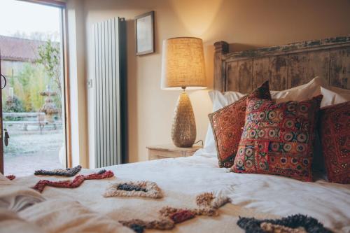 a bedroom with a bed with pillows and a window at Trading Boundaries in Uckfield