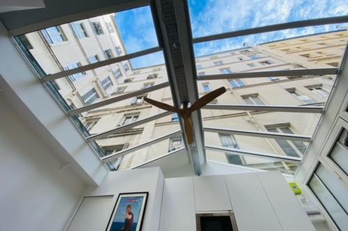 a room with a large glass window in a building at Warm 18m ideal for couple in Paris in Paris