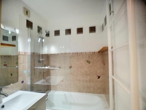 une salle de bain avec une baignoire, un lavabo et une douche dans l'établissement 2 Pièces + mezzanine 6 pers, ski aux pieds, wifi, parking - FR-1-178-15, aux Menuires