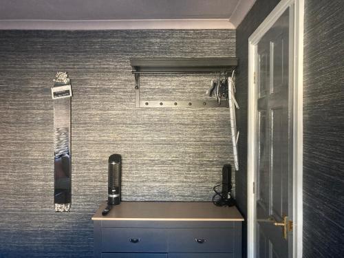 a bathroom with a sink and a phone on the wall at The Woodszz guest house in Whitby