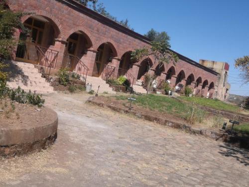 a brick building with arches on the side of it at Lalibela Hotel in Lalībela