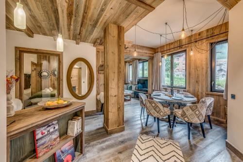 a dining room with a table and chairs at Hotel & Spa Le Val d'Isère in Val dʼIsère