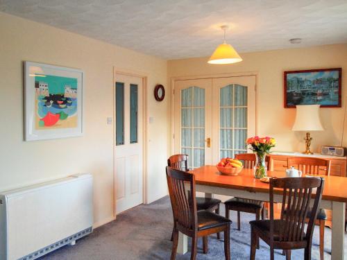 a dining room with a table and chairs at Chynoweth in Saint Merryn