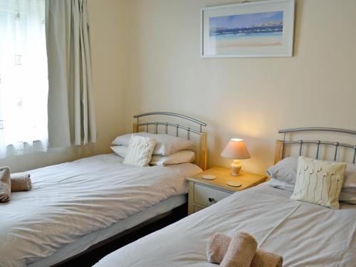 two beds sitting next to each other in a bedroom at Chynoweth in Saint Merryn